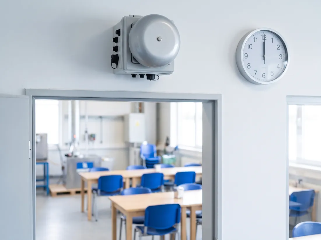 Netbell-K break bell system above a break room doorway with wall clock at 12